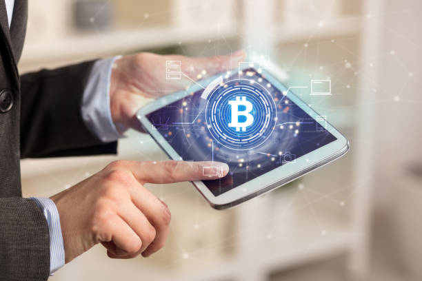 istock Business woman using tablet in home office mood with bitcoin link network concept 1182941131