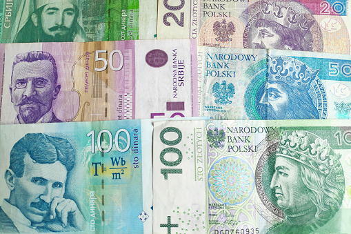 Close-up on a stack of Serbian Dinar and Polish Zloty.