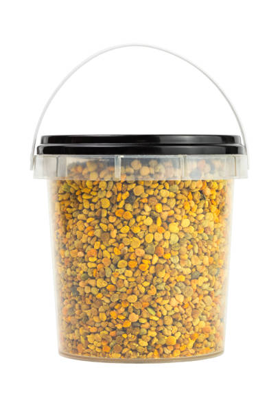 bee pollen granules in small plastic container isolated on white background - medicine closed antioxidant close to imagens e fotografias de stock