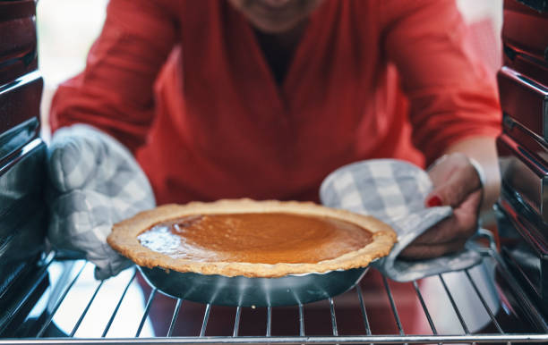 istock Baking Pumpkin Pie for the Holidays in the Oven 1182944523