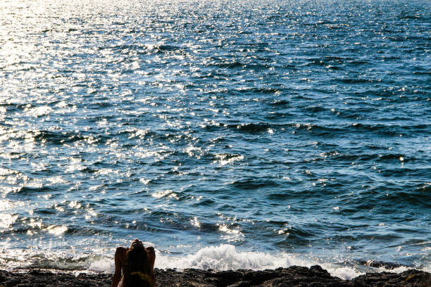 istock Woman alone at the rocky beach 1182944689