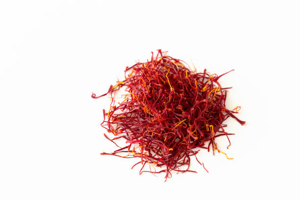 istock Dried red indian saffron spice isolate on white background. Aroma spice 1182944812