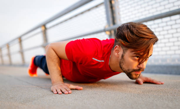istock Handsome fit man warming up before jogging outdoor 1182947957