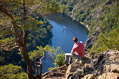Man looking on view of Vltava river horseshoe shape meander from Maj viewpoint, Czech Republic