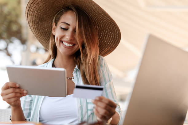 istock Young carefree woman e-banking while sitting in a cafe. 1182949487