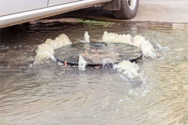 Photo of Accident sewerage system. Water flows over the road from the sewer. Water flows over the road from the sewer