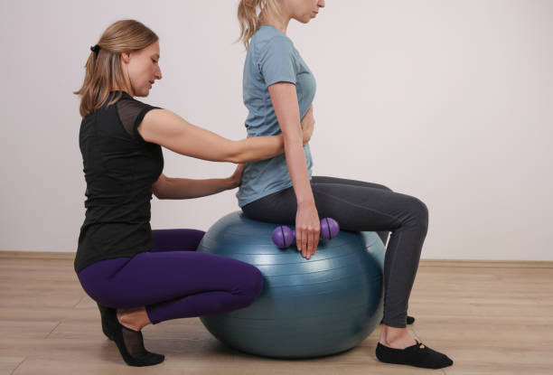 istock Pilates workout with personal trainer. Scoliosis, bad posture correction, Physiotherapy, Kinesiology 1182950100