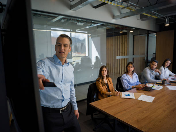 istock Business man in a board meeting making a presentation 1182950236