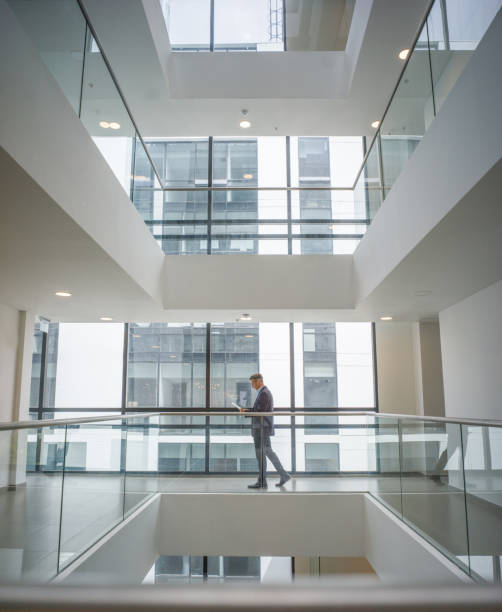 istock Business man walking at an office building 1182950249