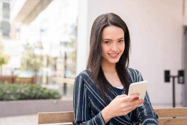 istock Business woman at a co-working space outdoors using her cell phone 1182950339