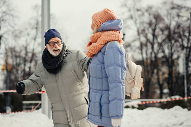 istock Elderly couple smiling while having fun outdoors 1182952579