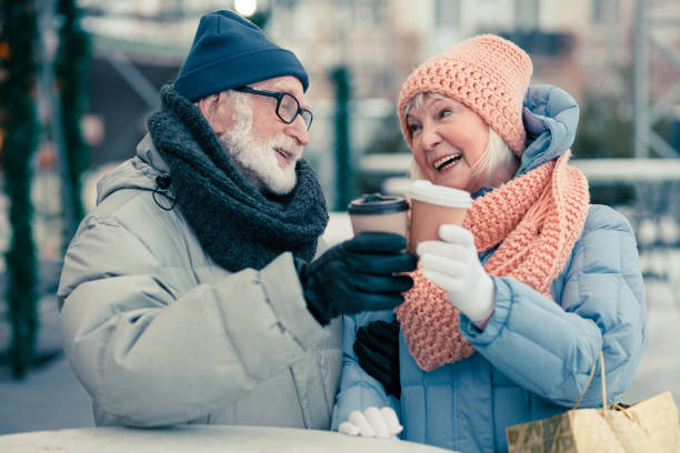 istock Aged couple celebrating and clanging cups of coffee 1182952921