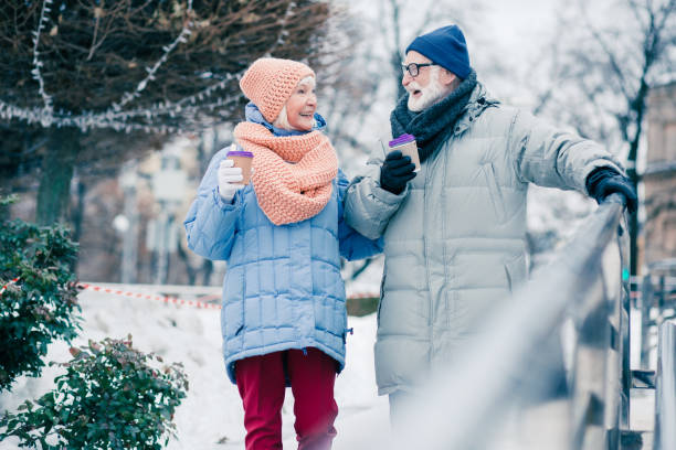 istock Happy pensioner putting hand on the handrail while walking with wife 1182953152