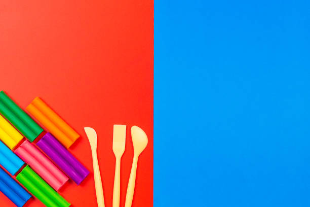 istock Plasticine for sculpting in different colors and a tool for working with it. Top view. Colored blocks. Copy your text 1182953488