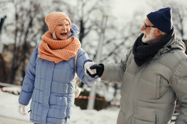istock Excited senior lady smiling to her husband while skating with him 1182953530