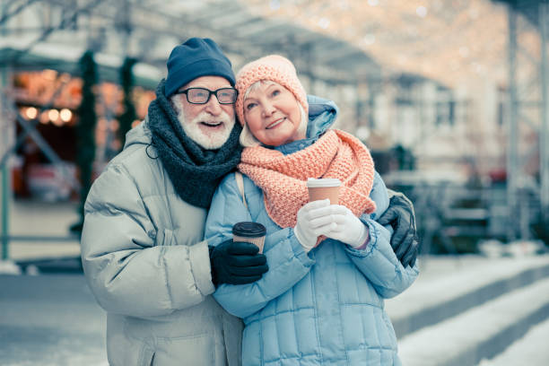 istock Happy elderly couple hugging outdoors in cold day 1182954796