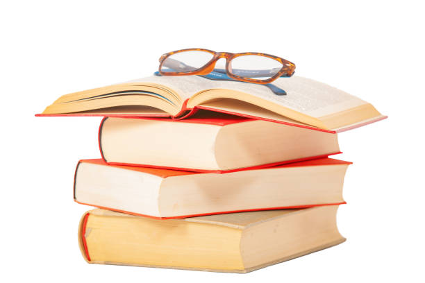 istock Glasses lies on red books 1182954948