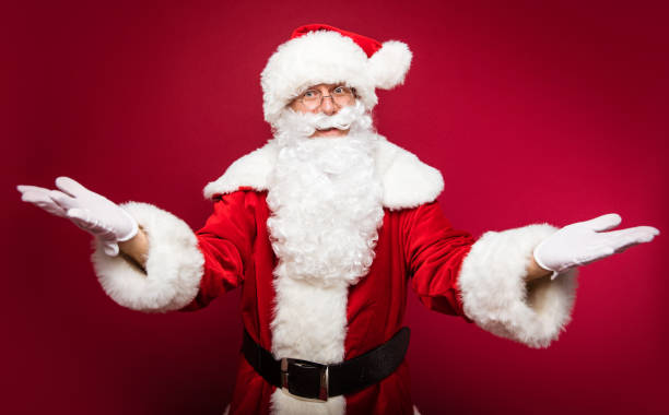 istock What a surprise! Authentic Santa Claus is posing spreading his hands for a hug or to express his astonishment. 1182956866