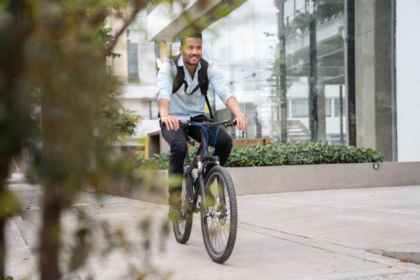 istock Happy man commuting to work riding a bicycle 1182958291