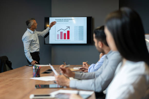 istock Business man presenting growth graphs in a meeting 1182958339
