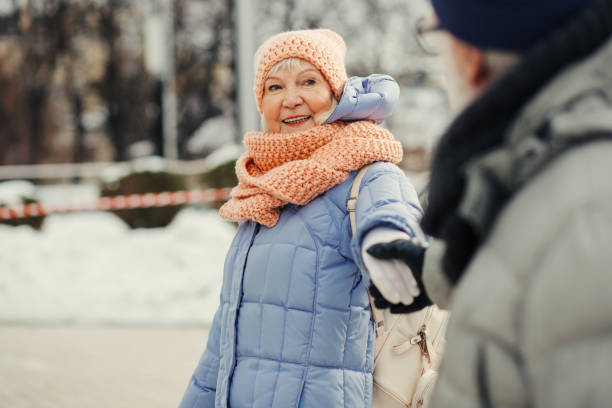 istock Pleased aged lady smiling while husband holding her hand 1182958359