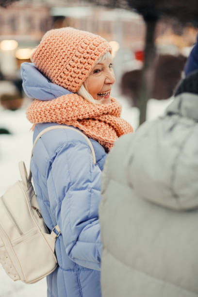 istock Delighted senior woman laughing while walking in winter 1182958485