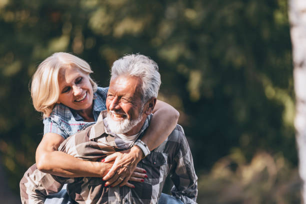 istock Senior couple piggyback riding 1182960631