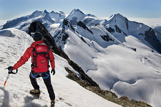 istock Mountaineer walks down along a snowy ridge 118296311
