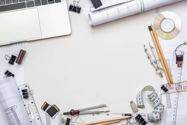 istock Architectural plans, pencil and ruler on the table. Laptop and workplace accessories. Place for your text. 1182964683
