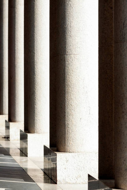 istock Colonnade, row of stone columns, background with copy spaced 1182964740