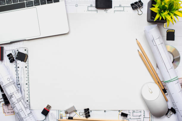 istock Architectural plans, pencil and ruler on the table. Laptop and workplace accessories. Place for your text. 1182964778