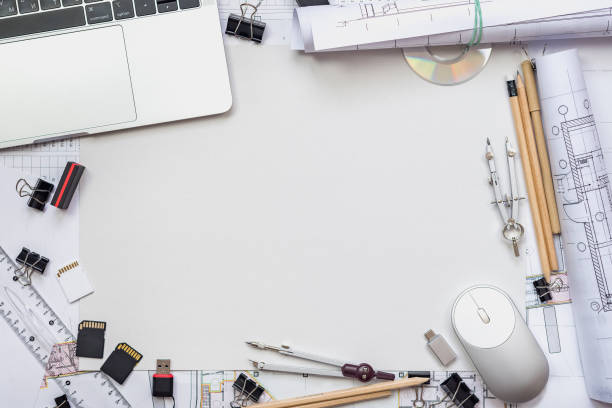 istock Architectural plans, pencil and ruler on the table. Laptop and workplace accessories. Place for your text. 1182964806