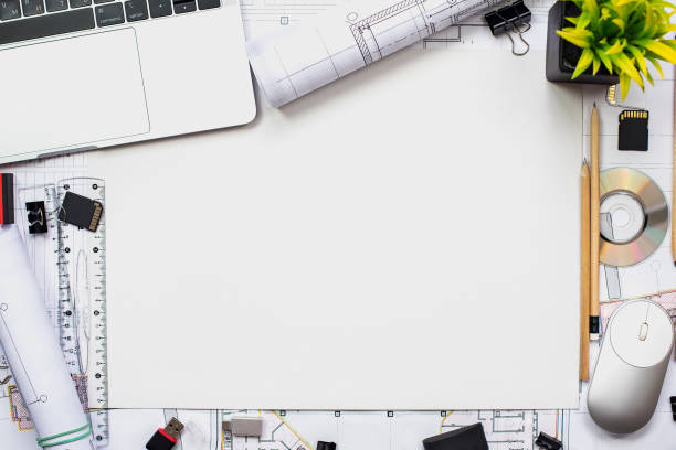 istock Architectural plans, pencil and ruler on the table. Laptop and workplace accessories. Place for your text. 1182964897