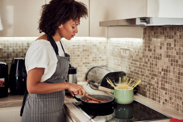 Woman preparing dinner. stock photo