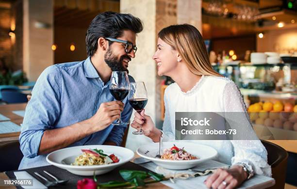 Paste And Red Wine Young Couple Enjoying Lunch In The Restaurant Lifestyle Love Relationships Food Concept Stock Photo - Download Image Now