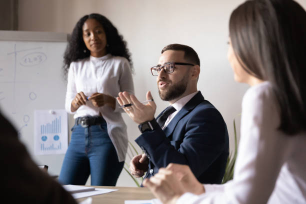 istock Confident male business leader talking during group office briefing 1182967277