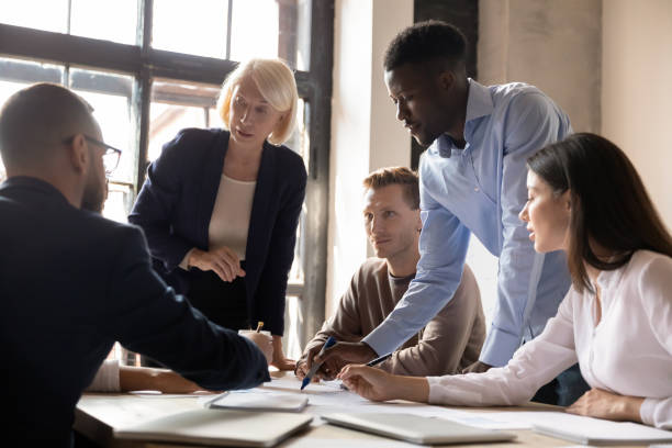 istock Busy multiethnic businesspeople group working together planning project at briefing 1182967292