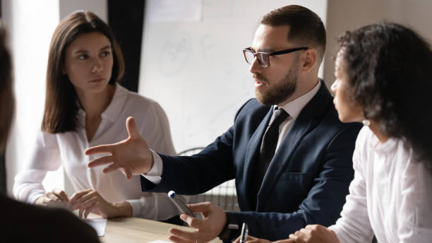 istock Serious successful businessman ceo teaching workers team at corporate training 1182967323