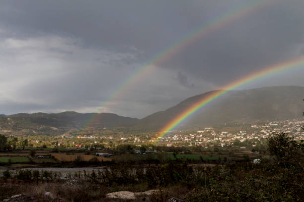 istock Double rainbow over a small village in the mountains 1182967481