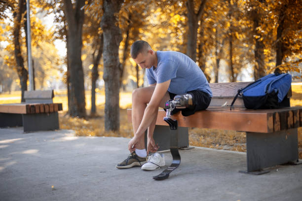 istock Young man without leg with prosthesis exercise in nature. 1182970050