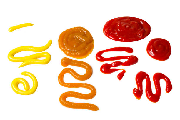 istock Ketchup and yellow sauce splashes isolated on white background. 1182970743