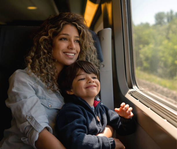 istock Happy mother and son riding on the train 1182972108