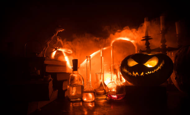 istock Halloween still-life background with different elements on dark toned foggy background. Selective focus 1182972344