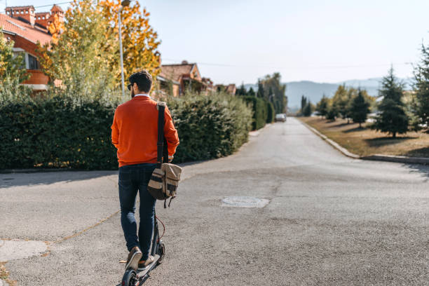 istock Man riding electric scooter on road 1182979145