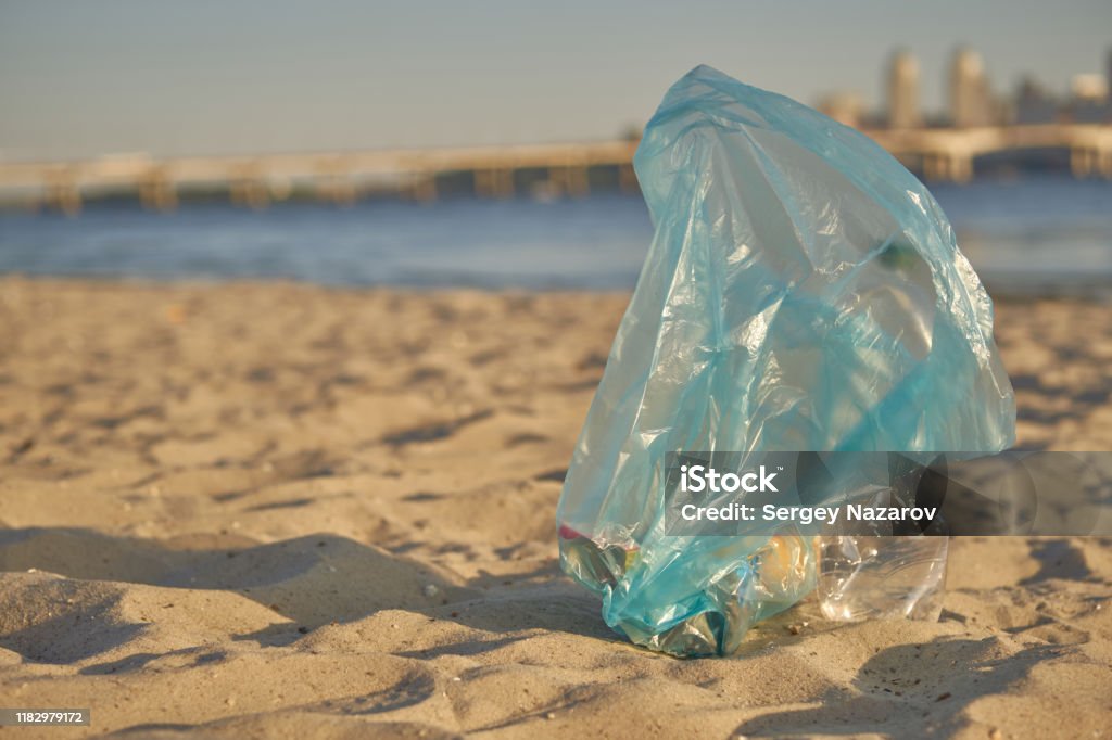 https://media.istockphoto.com/id/1182979172/photo/blue-bag-with-garbage-lies-on-beach-of-picturesque-river-cleaning-up-trash-riverside.jpg?s=1024x1024&w=is&k=20&c=1CUzLF8s_en8eQFoYD3xRROe5KTKA2u-bFXPfV4qBFg=