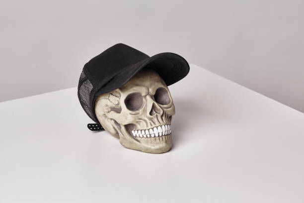 istock Realistic model of a human skull with teeth on a light table, white background. Medical science or Halloween horror concept 1182980160