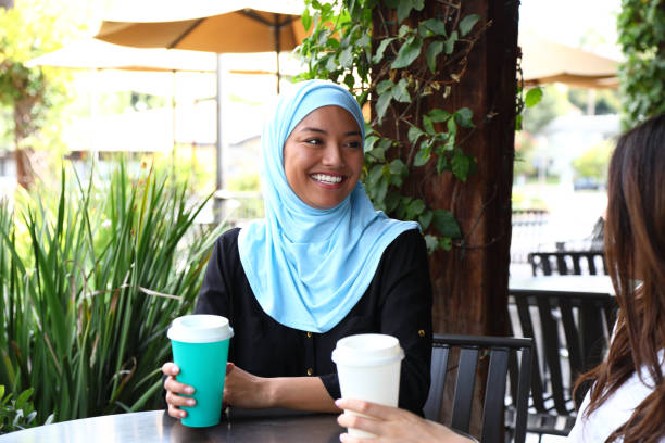istock Middle Eastern Woman Smiling and Drinking Coffee With Friend MS Horizontal 1182980534