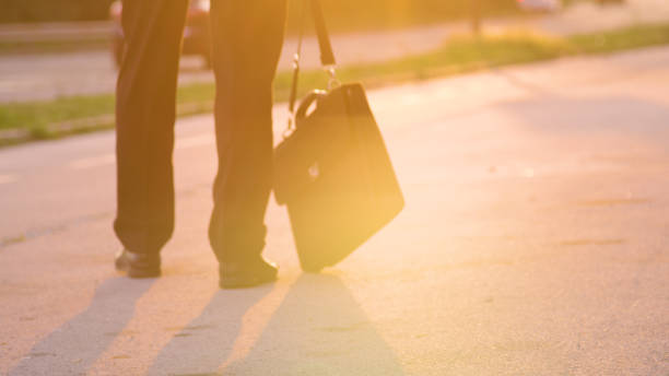 istock LOW ANGLE: Pessimistic young man slowly walking home after a job interview. 1182982590