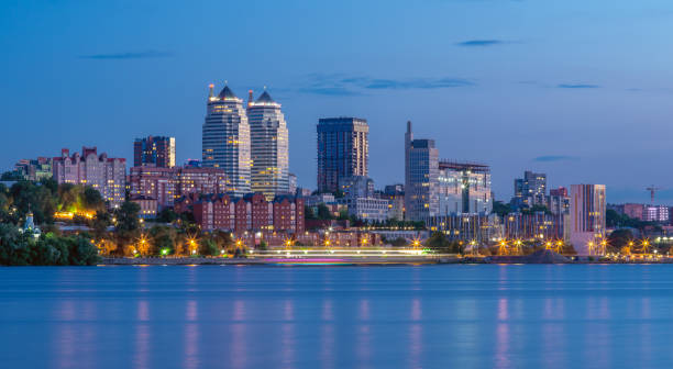 Panoramic view of the towers, skyscrapers, promenade in the evening, the lights are reflected on the Dnieper River, Ukraine. Dnipro city, Dnipropetrovsk Panoramic view of the towers, skyscrapers, tall buildings and promenade in the evening, the lights are reflected on the Dnieper River, Ukraine. Dnipro city, Dnipropetrovsk. dnipropetrovsk stock pictures, royalty-free photos & images