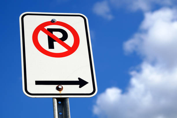 no parking traffic sign icon city law police ticket warning blue sky clouds stock photo